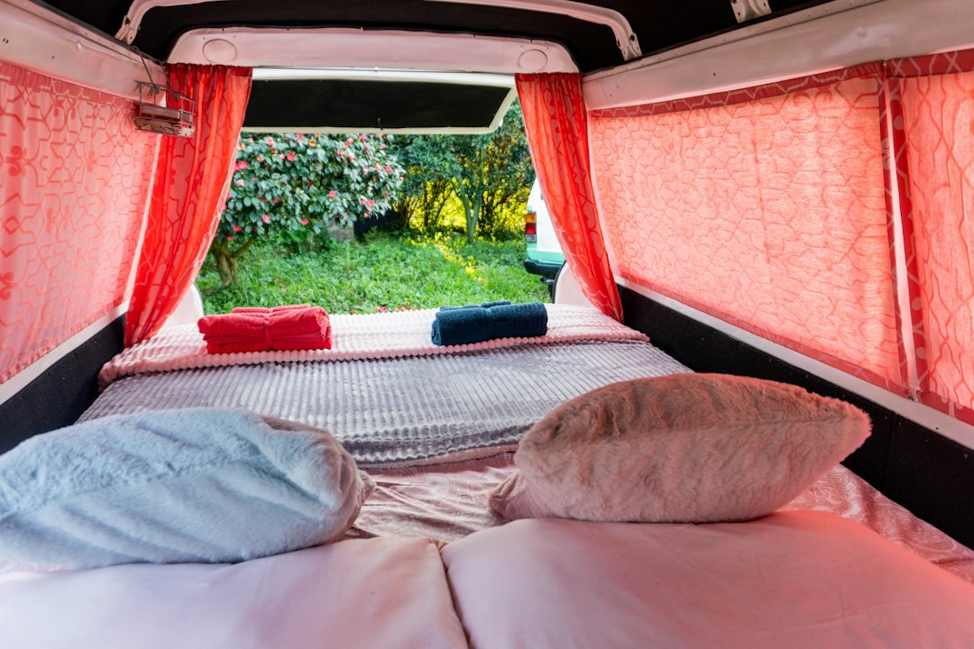 A campervan interior with curtains drawn over the bed window